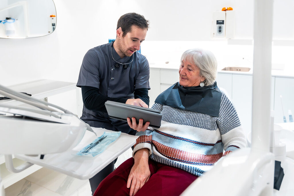 Dentist reviewing a treatment plan with an older patient