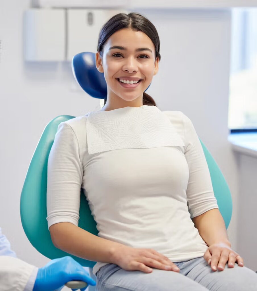 Smiling patient seated in a dental chair