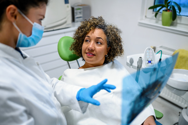 Dentist reviewing a dental X-ray with a patient